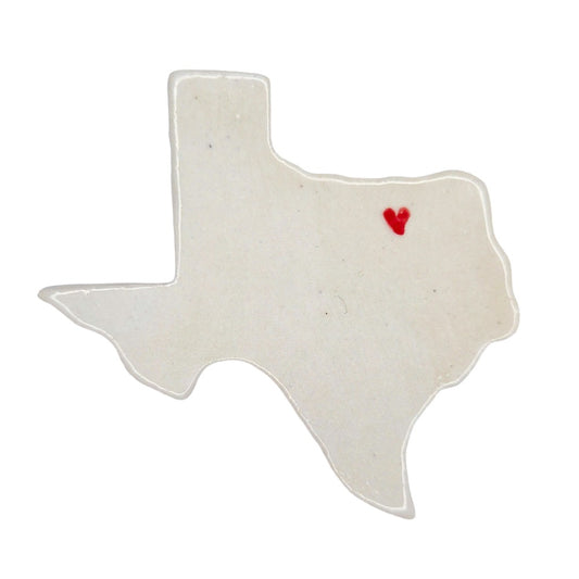 Texas-shaped white ceramic magnet with a red heart on a white background