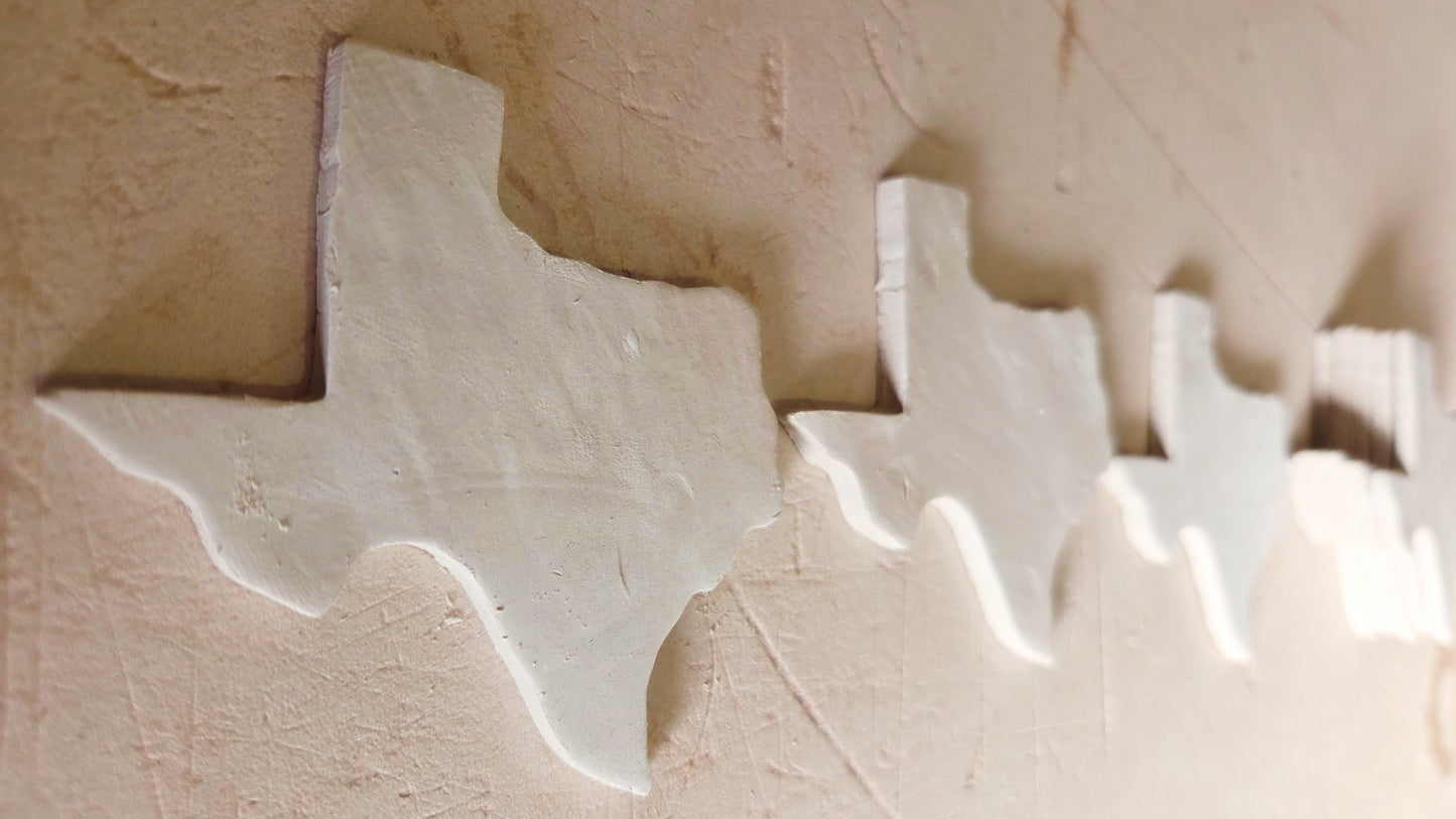 Raw ceramic Texas state shape magnet before glazing and personalization into custom souvenir magnets
